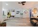 Open concept living room with wood look floors, casual seating, and access to other rooms at 7404 Bay Dr, Tampa, FL 33635