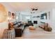 Comfortable living room with a leather sectional, stone fireplace, and modern decor at 7404 Bay Dr, Tampa, FL 33635