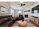 Inviting living room featuring a stone fireplace, comfortable leather sectional, and stylish decor at 7404 Bay Dr, Tampa, FL 33635