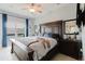 Spacious bedroom with ceiling fan, neutral walls, and dark wood furniture at 7404 Bay Dr, Tampa, FL 33635