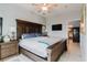 Large main bedroom featuring wood furniture, neutral walls, ceiling fan, and en suite bathroom at 7404 Bay Dr, Tampa, FL 33635