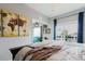 Bright bedroom with sliding glass door to balcony, neutral walls, and wood-look flooring at 7404 Bay Dr, Tampa, FL 33635