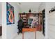A modern office with wood desk, shelving, sleek white filing cabinet and neutral walls offers a serene workspace at 7404 Bay Dr, Tampa, FL 33635