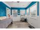 Sun room with bright blue walls, tiled floors, and well-lit windows at 7404 Bay Dr, Tampa, FL 33635