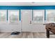 A spacious sun room featuring bright blue walls, tiled floors, and well-lit windows at 7404 Bay Dr, Tampa, FL 33635