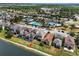 Aerial view of lakeside homes showcasing community pool and amenities at 7699 Windchase Way, Wesley Chapel, FL 33545