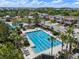 An overhead shot showing a large, resort-style swimming pool with lounge areas, palm trees, and community amenities at 7699 Windchase Way, Wesley Chapel, FL 33545