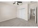 Bright bedroom with carpet, ceiling fan, and a closet with large, sliding doors at 7699 Windchase Way, Wesley Chapel, FL 33545