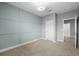 Bedroom with decorative trim, carpet, and a door at 7699 Windchase Way, Wesley Chapel, FL 33545