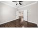 Bedroom with hardwood floors and views into an adjoining room at 7699 Windchase Way, Wesley Chapel, FL 33545