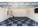 Spacious garage with epoxy flooring, water heater, and garage door opener at 7699 Windchase Way, Wesley Chapel, FL 33545