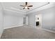 Spacious main bedroom with a fan and ensuite bathroom at 7699 Windchase Way, Wesley Chapel, FL 33545