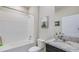 Bright bathroom featuring a tub with white tiled walls and a granite-topped vanity at 7763 Wheat Stone Dr, Zephyrhills, FL 33540
