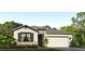 Charming single-story home featuring a two-car garage and stone accents at 7763 Wheat Stone Dr, Zephyrhills, FL 33540