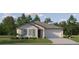 Charming single-Gathering home featuring a well-manicured lawn, gray shutters, and a two-car garage at 7796 Painted Sky Pl, Land O Lakes, FL 34637