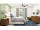 Serene bedroom with a large window, soft lighting and view of exterior grounds at 7796 Painted Sky Pl, Land O Lakes, FL 34637
