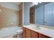 Bathroom with tile flooring and shower-tub combination, and a light wood vanity at 7901 Seminole Blvd # 1103, Seminole, FL 33772