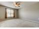 Spacious bedroom with a ceiling fan, plush carpet, a window, and neutral paint at 7901 Seminole Blvd # 1103, Seminole, FL 33772