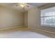 Carpeted bedroom featuring a window with white blinds for natural light at 7901 Seminole Blvd # 1103, Seminole, FL 33772
