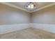 Empty bedroom featuring neutral paint, chair rail, and ceiling fan at 7901 Seminole Blvd # 1103, Seminole, FL 33772