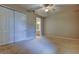 Neutral bedroom featuring ceiling fan, large closet, and view into the ensuite bathroom at 7901 Seminole Blvd # 1103, Seminole, FL 33772