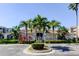 Community clubhouse featuring tropical landscaping, covered entrance, and convenient parking at 7901 Seminole Blvd # 1103, Seminole, FL 33772