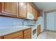 Kitchen with cabinets, white appliances, and tile floors at 7901 Seminole Blvd # 1103, Seminole, FL 33772