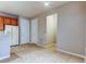 Neutral toned kitchen with tile floors, a refrigerator, two white doors, and a small entryway at 7901 Seminole Blvd # 1103, Seminole, FL 33772