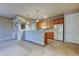 Open kitchen featuring wooden cabinets, a refrigerator, tile flooring, and track lighting at 7901 Seminole Blvd # 1103, Seminole, FL 33772