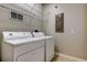 Cozy laundry room featuring a washer, a dryer, wire shelving, and tile flooring at 7901 Seminole Blvd # 1103, Seminole, FL 33772