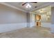 Living room with view of kitchen, ceiling fan, and neutral paint at 7901 Seminole Blvd # 1103, Seminole, FL 33772