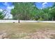 Expansive backyard with mature trees and a white privacy fence, perfect for outdoor activities at 808 Hickory Glen Dr, Seffner, FL 33584