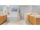 Bathroom featuring double sinks, a large tub, and glass enclosed shower at 808 Hickory Glen Dr, Seffner, FL 33584