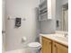 Bathroom features a toilet, wood vanity, sink, and wall shelving at 808 Hickory Glen Dr, Seffner, FL 33584
