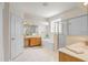 Bright bathroom with double sinks, tub, and glass enclosed shower at 808 Hickory Glen Dr, Seffner, FL 33584