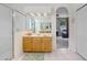 Bathroom featuring walk in shower, wooden cabinets and an arched doorway at 808 Hickory Glen Dr, Seffner, FL 33584