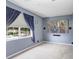 Bedroom featuring theater projector screen, blue walls and curtained windows at 808 Hickory Glen Dr, Seffner, FL 33584