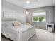 Bright bedroom features a white bed frame, white nightstand, ceiling fan, and natural light at 808 Hickory Glen Dr, Seffner, FL 33584