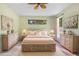 Serene bedroom boasts light green walls, coordinating decor, two dressers, and ample natural light at 808 Hickory Glen Dr, Seffner, FL 33584