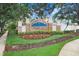 Decorative Lake Weeks community entrance sign surrounded by beautiful landscaping and flowers at 808 Hickory Glen Dr, Seffner, FL 33584