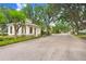 View of the community entrance with well-maintained landscaping, street and signage at 808 Hickory Glen Dr, Seffner, FL 33584