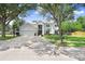 Home exterior with a large driveway, a basketball hoop, and lush landscaping at 808 Hickory Glen Dr, Seffner, FL 33584