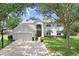 Charming two-story home with a well-manicured lawn, attached garage, and inviting curb appeal at 808 Hickory Glen Dr, Seffner, FL 33584