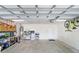 Spacious garage, featuring storage shelves, room for vehicles, and a white door at 808 Hickory Glen Dr, Seffner, FL 33584