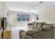 Spacious living room with fan, carpet, large sectional sofa, media console and window at 808 Hickory Glen Dr, Seffner, FL 33584