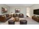 Comfortable staged living room with leather furniture, and two framed landscape pictures at 808 Hickory Glen Dr, Seffner, FL 33584
