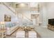 Bright living room features high ceilings, staircase, and elegant furnishings in neutral tones and a decorative area rug at 808 Hickory Glen Dr, Seffner, FL 33584