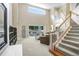 Bright and airy living room with tall ceilings, a staircase, and a view of the backyard at 808 Hickory Glen Dr, Seffner, FL 33584