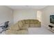 Living room featuring an oversized sectional sofa, carpet, television and desk at 808 Hickory Glen Dr, Seffner, FL 33584