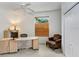 Well-lit home office with a ceiling fan, desk, chair, and storage cabinets at 808 Hickory Glen Dr, Seffner, FL 33584